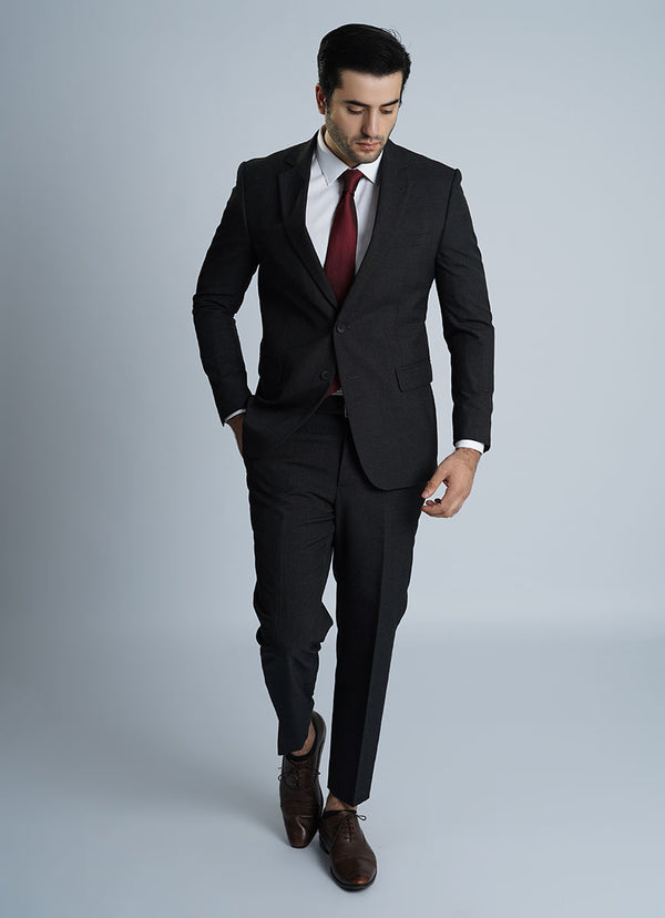 A model wearing a classic black men's formal suit from Lawrencepur, made from all-season wool rich Tropical Classic fabric.