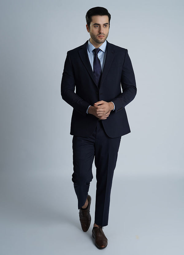 A man in a sharp blue formal suit, showcasing the premium wool blend fabric suitable for Pakistan's climate.